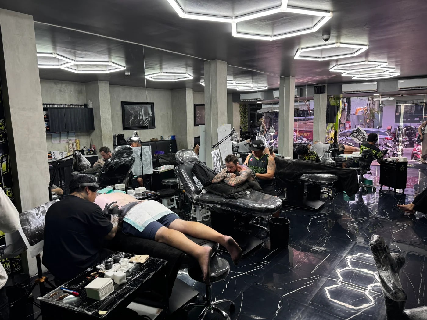 Clean professional Bloodline Tattoo Bali studio floor with multiple artists working