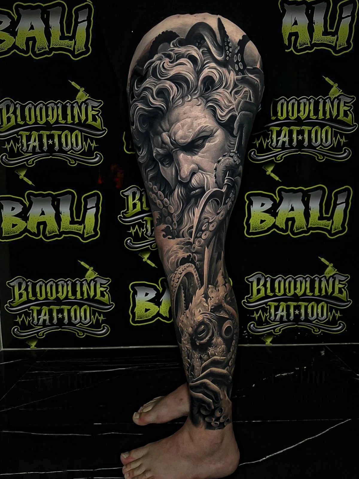 Healed mythological leg sleeve with a bearded sea god, octopus tentacles, and underwater realism, showing soft healed shading at Bloodline Tattoo Bali.