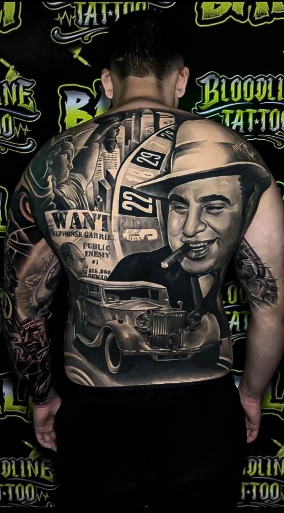Healed gangster backpiece with Al Capone portrait, wanted poster, and vintage car, showing crisp realism and settled greywash at Bloodline Tattoo Bali.